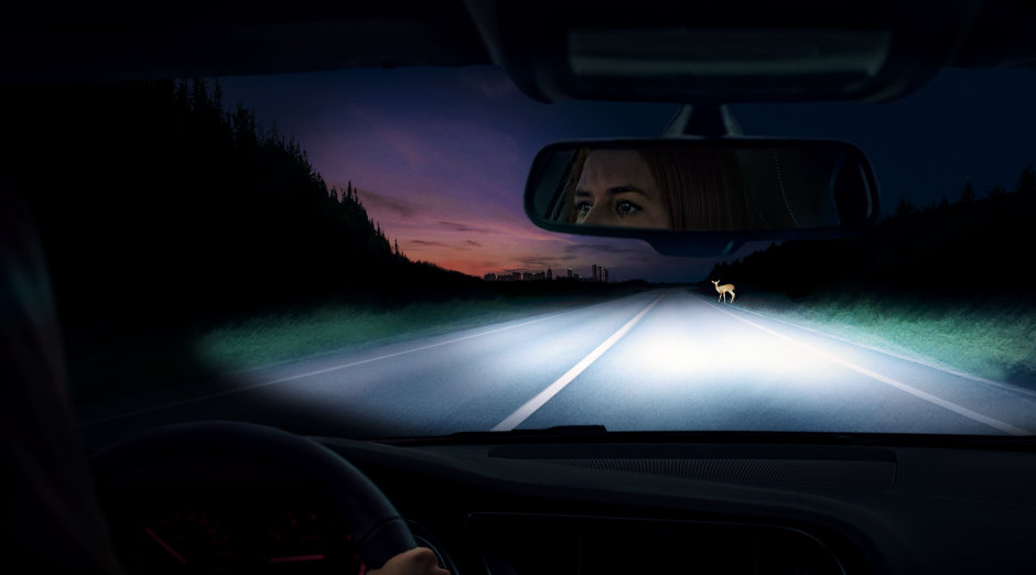 Woman drives at dawn in car with NIGHT BREAKER 200 lamps